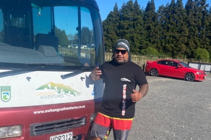a man standing in front of a bus