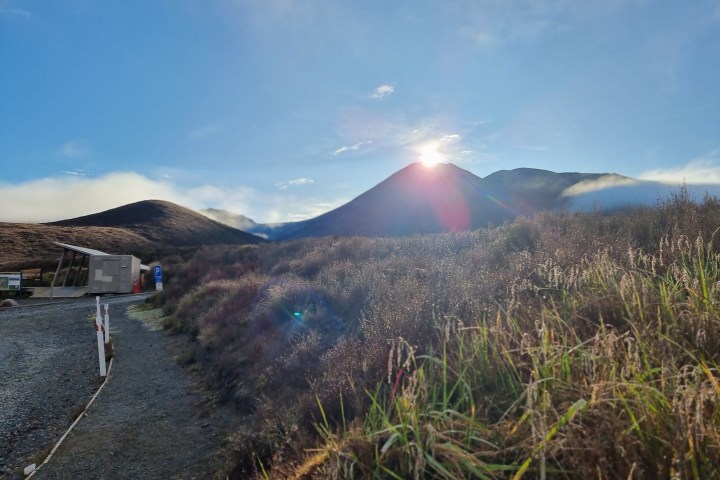 a person standing in front of a mountain
