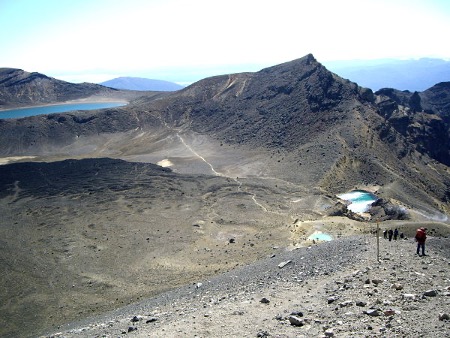 stage4 a group of people on a beach with a mountain in the background