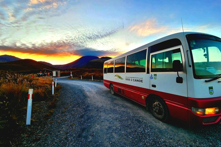 a bus parked in front of a body of water